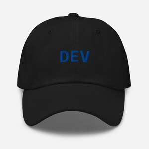 May include: Black baseball cap with the word "DEV" embroidered in blue. The cap has a curved brim and an adjustable strap at the back. A classic, casual accessory.