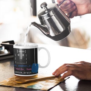 May include: A white ceramic mug with a black background featuring computer code and the text "Hello, human, optimize_brain." A stainless steel teapot pours hot water into the mug. A blue tea bag hangs from the mug.