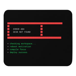 May include: Black mousepad with a red and green computer-themed design. The text reads "ERROR 404 DESK NOT FOUND" in red, with additional green text below. The design includes a simulated computer interface.