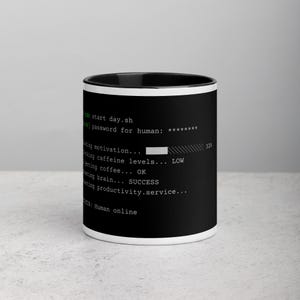 May include: A black ceramic mug with a white interior and rim, featuring a computer terminal interface graphic in white and green text. The text displays command lines including sudo start day.sh, password for human, and status: Human online.