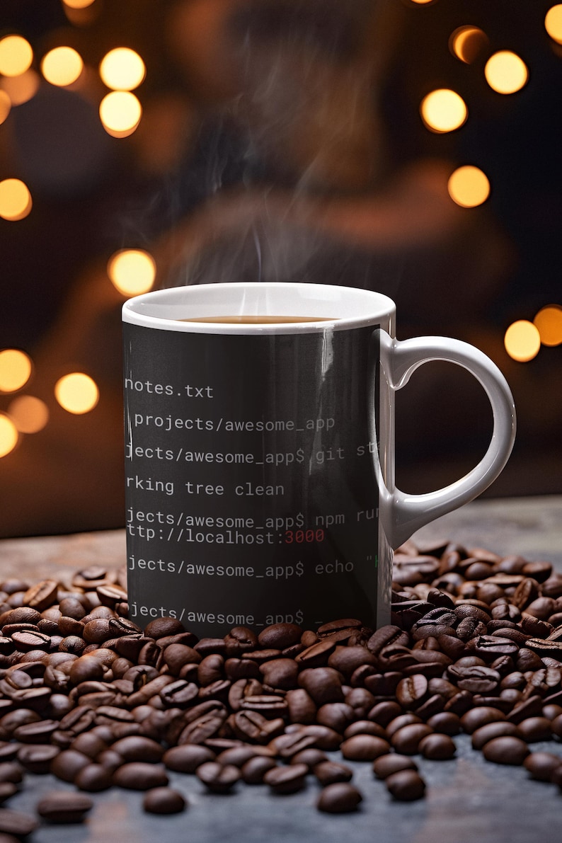 May include: A white ceramic mug with a black exterior featuring white terminal command line text including notes.txt, projects/awesome_app, git status, working tree clean, npm run, and echo. The mug contains a hot beverage with visible steam.