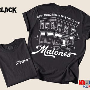 a black t-shirt with a graphic design depicting a building and the text "Malone's" above it.
