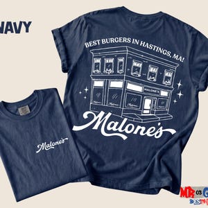 Navy t-shirt with a graphic design of a building and the text "Best Burgers in Hastings, MA!"