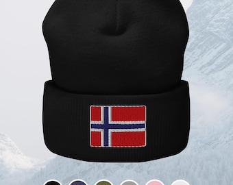 May include: Black beanie with the Norwegian flag embroidered on the front. The flag features a blue cross with white borders on a red background. The beanie is made of a soft, knitted material and is suitable for cold weather.