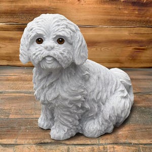 May include: A detailed, gray-colored dog statue with brown eyes. The sculpture features a fluffy coat and is sitting on a wooden surface. The dog statue is a decorative item.