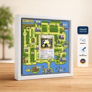 May include: A white square shadow box frame containing a pixelated map of the Kanto region with a centered Snorlax trading card. The frame features magnetic closure, UV protection, and measures 24 by 24 inches, as indicated by the side label.