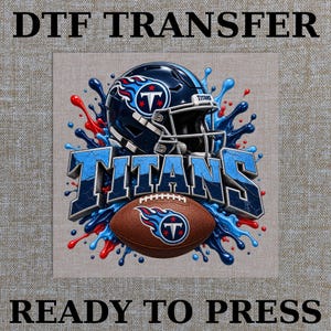 May include: A DTF TRANSFER READY TO PRESS graphic featuring a dark blue football helmet with the Titans logo, a brown football with the same logo, and the word TITANS in blue block letters, all surrounded by blue and red paint splashes.