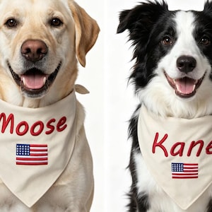 May include: Two dogs wearing cream-coloured triangular pet bandanas. The left bandana features the embroidered red text Moose above a small American flag. The right bandana features the embroidered red text Kane above a small American flag.