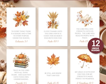 Op de afbeelding: Een set van 12 bijbeltekstkaarten met herfstthema, voorzien van aquarelillustraties van herfstbladeren, tarwe, een duif, boeken met een pompoen en een paraplu. Elke kaart toont een uniek vers en een bronvermelding in serif-lettertype.