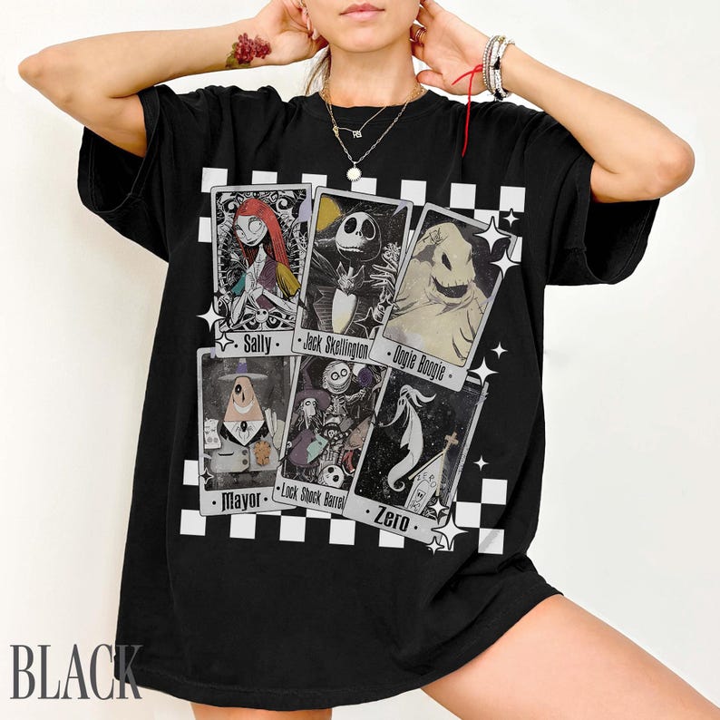 May include: Black t-shirt featuring playing card designs with characters from The Nightmare Before Christmas. The cards include Sally, Jack Skellington, Oogie Boogie, Mayor, Lock, Shock, Barrel, and Zero. The word "BLACK" is printed at the bottom.