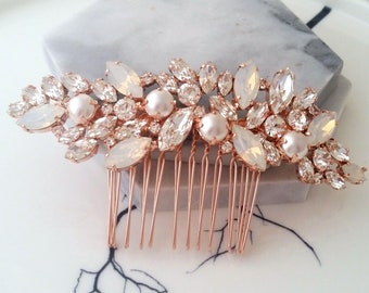 May include: Rose gold hair comb with a cluster of clear and opal rhinestones and faux pearls.