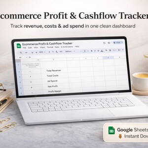 May include: A white laptop displays a Google Sheets template titled "Ecommerce Profit & Cashflow Tracker." The screen shows a spreadsheet with columns for revenue, costs, and ad spend. A cup of coffee, glasses, and a pen are on the table.