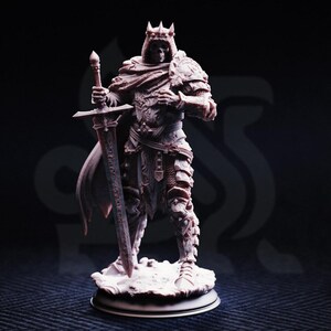 May include: A detailed figurine of a skeletal king wearing a crown and armor, holding a sword. The figure is standing on a small, round base. The color is a muted, off-white with intricate details, suggesting a fantasy or historical theme.