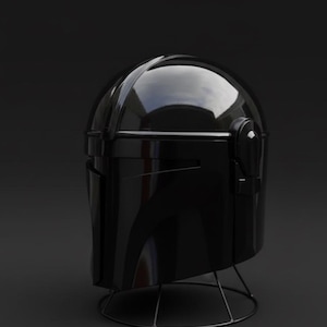 May include: A shiny black helmet, possibly for costume or display purposes, is set against a dark backdrop. The helmet has a smooth, reflective finish and is held up by a slender, wire stand. The design hints at a futuristic or science fiction aesthetic.