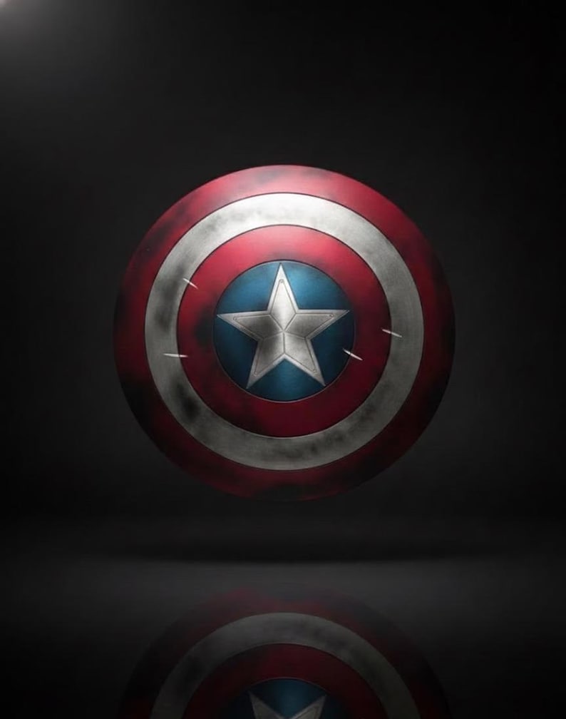 May include: A Captain America shield, featuring a red, white, and blue color scheme. The shield has a central blue circle with a white star, surrounded by white and red concentric rings. The shield appears aged with distressed details.