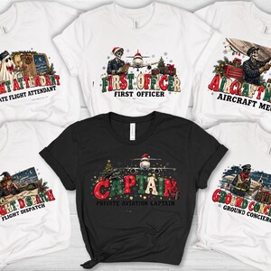 May include: A collection of five t-shirts, four white and one black, each featuring a festive aviation-themed graphic. The designs include illustrations of skeletons or characters in aviation roles like Captain, First Officer, and Flight Attendant.