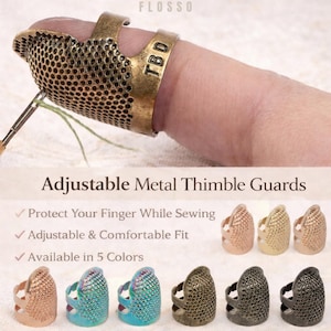 May include: An antique brass-coloured metal thimble guard with the text "TBD" is worn on a finger. The image also shows several other thimble guards in various colours. The text "Adjustable Metal Thimble Guards" is displayed.