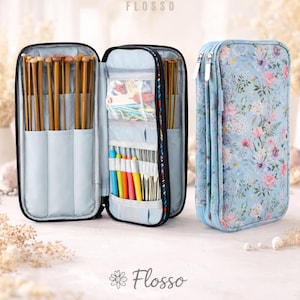 May include: A light blue, zippered knitting needle case with a floral pattern. The case is open, revealing wooden knitting needles and colorful crochet hooks. The brand name "Flosso" is visible at the top and bottom of the image.