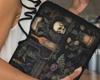 May include: A black laptop sleeve with a dark floral and skull design. The sleeve is made of a soft, durable material and features a zipper closure.