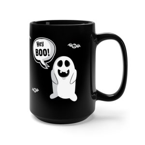 May include: Black ceramic coffee mug with a white ghost graphic and the text "Hey BOO!" in a speech bubble. There are also small bat graphics on the mug.