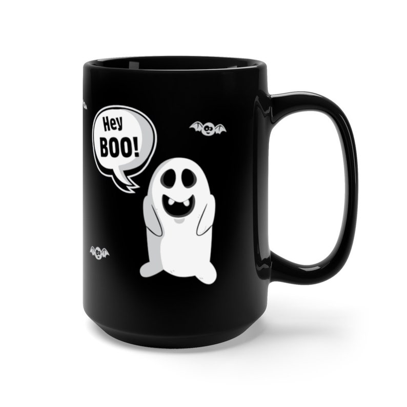 May include: Black ceramic coffee mug with a white ghost graphic and the text "Hey BOO!" in a speech bubble. There are also small bat graphics on the mug.
