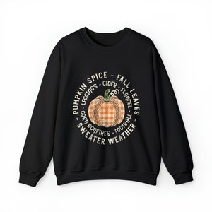 May include: Black sweatshirt with a white circle graphic featuring a pumpkin with a plaid pattern and the text "Pumpkin Spice - Leggings - Cider - Fall Leaves - Corn - Bonfires - Flannel - Football - Sweater Weather".