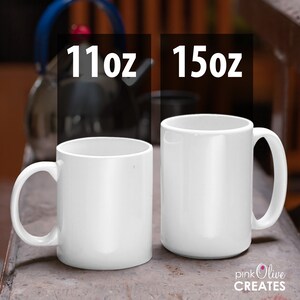 May include: Two white ceramic mugs, one 11oz and one 15oz, on a wooden surface.