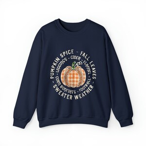 May include: Navy blue sweatshirt with a white circle graphic featuring a pumpkin with a plaid pattern and the text "Pumpkin Spice - Fall Leaves - Leggings - Cider - Flannel - Corn Bonfires - Football - Sweater Weather".