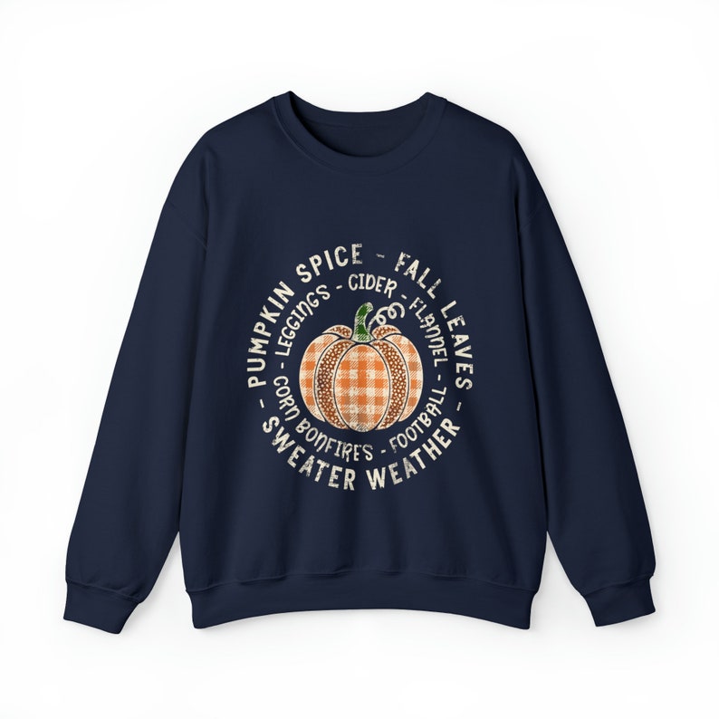 May include: Navy blue sweatshirt with a white circle graphic featuring a pumpkin with a plaid pattern and the text "Pumpkin Spice - Fall Leaves - Leggings - Cider - Flannel - Corn Bonfires - Football - Sweater Weather".