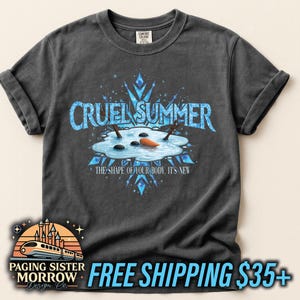 May include: Dark gray t-shirt with the text "CRUEL SUMMER" in blue, featuring a snowman melting in a puddle. The shirt also has the text "THE SHAPE OF YOUR BODY, IT'S NEW".