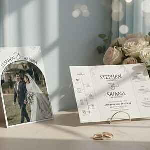May include: Wedding invitations featuring the names "Stephen & Ariana" with a photo of the couple. The invitations are displayed with a bouquet of roses and wedding rings. The invitation includes the date, August 12, 20XX.