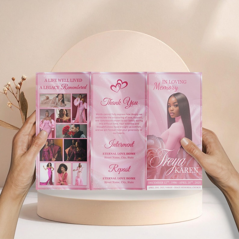 May include: A pink memorial brochure held by hands, featuring photos and text. The brochure includes the phrases "A Life Well Lived, A Legacy Remembered", "Thank You", and "In Loving Memory". It also lists dates and a name.