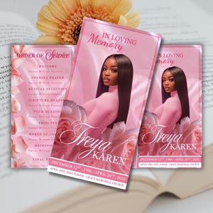 May include: Pink memorial service programs with the text "In Loving Memory" and the name "Freya Karen." The programs feature a photo of a woman and floral accents. The order of service is also visible.