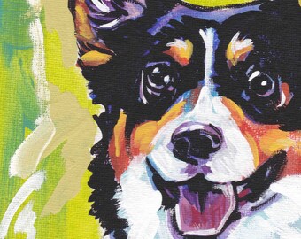 May include: A colorful painting of a corgi dog with black, white, orange, and brown fur. The dog is looking directly at the viewer with its mouth open and tongue sticking out. The background is a bright green and yellow.