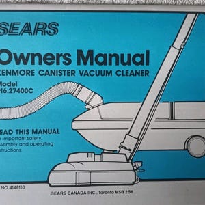 Könnte beinhalten: Eine Bedienungsanleitung für einen Kenmore Kanister-Staubsauger von Sears mit blauem Einband. Die Anleitung zeigt eine Strichzeichnung des Staubsaugers, die Modellnummer 116.27400C und den Text: READ THIS MANUAL for important safety, assembly and operating instructions.