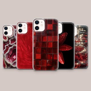 May include: A collection of five phone cases with various designs. The cases feature a range of red hues, including a geode pattern, a marbled effect, a mosaic of squares, a floral design, and a water-like pattern with lights.