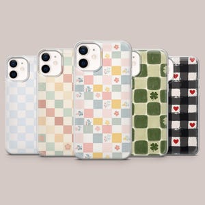 May include: Five phone cases with different checkerboard patterns. Designs include pastel blue, peach, floral, green with clovers, and black and white with red hearts. Each case has a clear border.