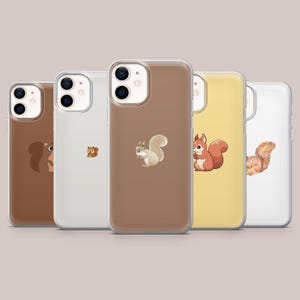 May include: A collection of five phone cases with different colored backgrounds, each featuring a cartoon squirrel design. The cases are in shades of brown, white, and yellow. The squirrel illustrations vary in style and pose.