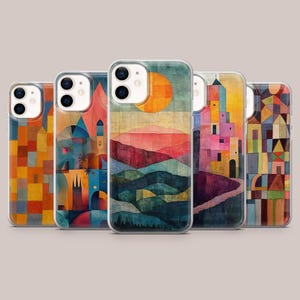 May include: A collection of five phone cases with abstract landscape art. Each case features a different design, including colorful mountains, a setting sun, and geometric shapes. The cases are in clear protective covers.
