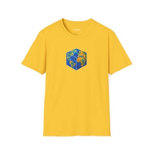May include: A yellow t-shirt featuring a cube design with a world map graphic. The cube shows the continents and oceans in shades of blue, green, and brown. The shirt has short sleeves and a crew neck.