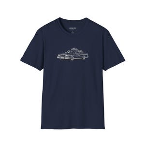 May include: A navy blue short-sleeve t-shirt featuring a white line art graphic of a vintage taxi cab on the chest. The taxi illustration includes the text "TAXI" on the roof sign and the number "1729" on the side door panel of the vehicle.