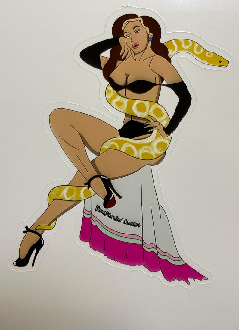 May include: A die-cut sticker featuring an illustration of a person with long brown hair wearing black lingerie, opera gloves, and high heels. A large yellow and white snake is coiled around the figure. The text FindMairStef Creative is visible.