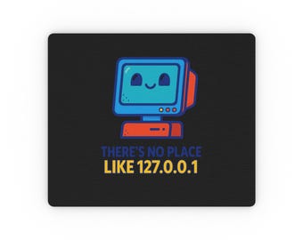 May include: A rectangular black mouse pad featuring a cartoon computer monitor with a smiling face in blue and red. Below the monitor, the text reads "THERE'S NO PLACE LIKE 127.0.0.1" in blue and yellow lettering on the black background.