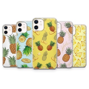 May include: A selection of phone cases with pineapple patterns. The cases display a range of colours, including white, light blue, yellow, pink, and yellow, with repeating pineapple designs and slices. The cases are made of a clear material.