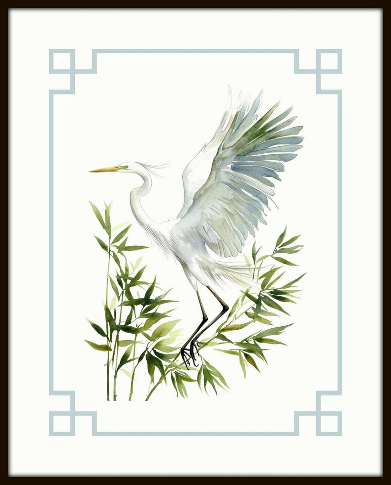 May include: Watercolor painting of a white egret with outstretched wings, perched among green bamboo stalks. The artwork is framed with a light blue border and a dark brown frame, creating a serene and natural aesthetic.
