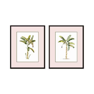 May include: Two framed botanical prints of banana plants with green leaves and brown stems. The prints are set against a light pink background and have black frames.