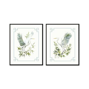 May include: Two framed art prints featuring white herons with outstretched wings, set against a backdrop of bamboo and a light blue geometric border. The artwork is in a watercolor style, with a minimalist aesthetic.
