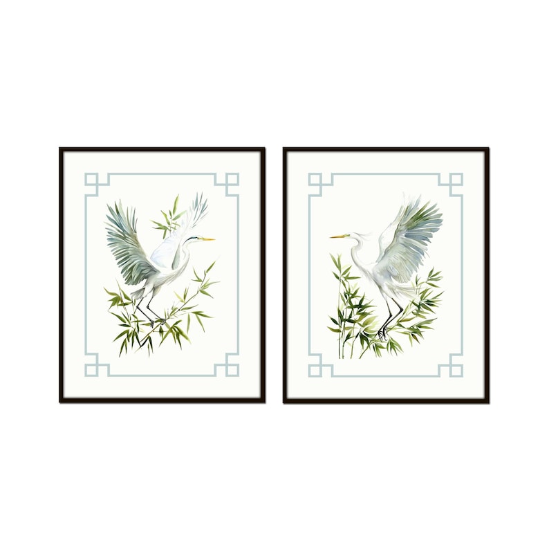 May include: Two framed art prints featuring white herons with outstretched wings, set against a backdrop of bamboo and a light blue geometric border. The artwork is in a watercolor style, with a minimalist aesthetic.