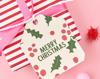 May include: A red and white striped gift box with a pink ribbon and a gift tag that says "Merry Christmas". The tag has a green holly leaf and red berry pattern.