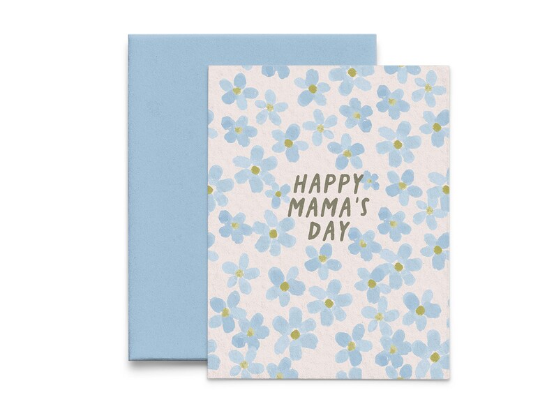 May include: A greeting card with a light blue floral pattern and the text "Happy Mama's Day" in brown lettering.